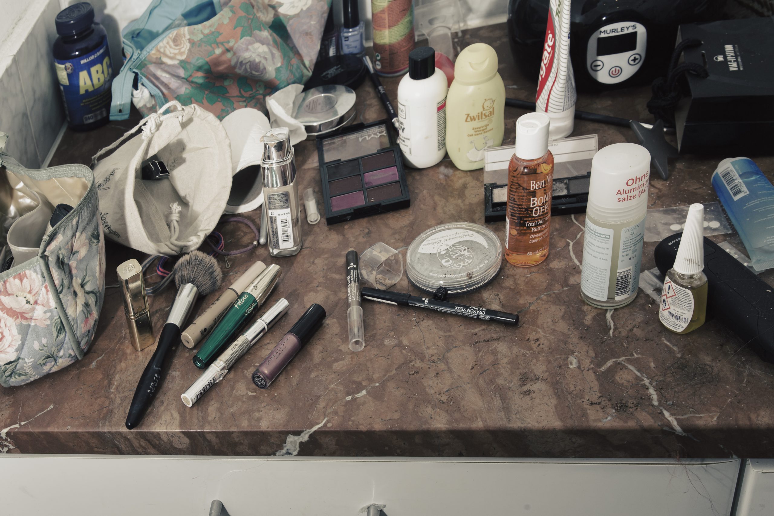Foto van een tafel vol make-up en toiletartikelen, rommelig uitgestald voor een documentaire. Autonoom georganiseerd. Joep van Drunen Photography