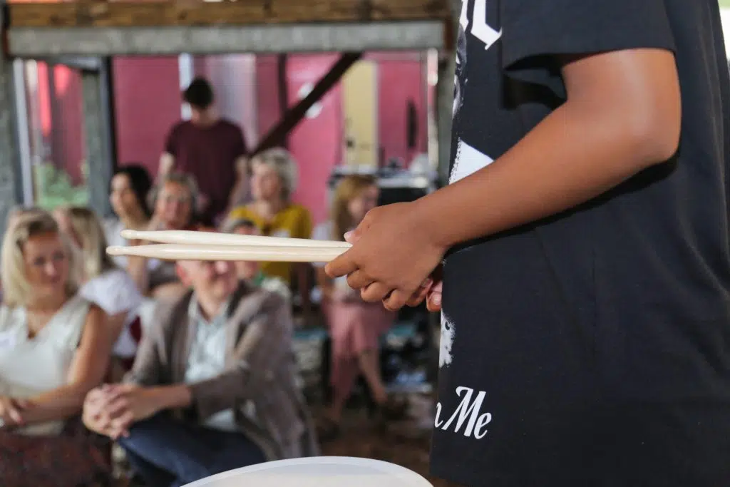 Jonge drummer met drumstokken voor publiek, Joep van Drunen Photography