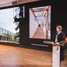 Uitreiking Abe Bonnema Prijs. Spreker op podium met foto's van architectuurprojecten. JVD_9135 Joep van Drunen Photography